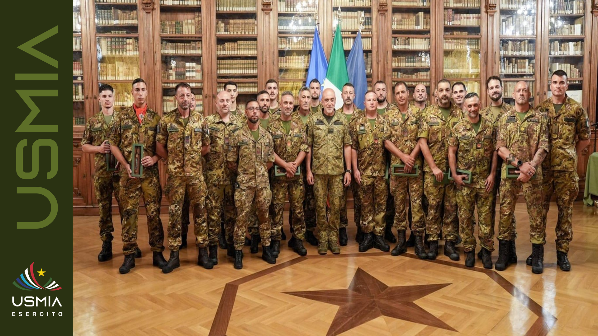Militari dell’Esercito Italiano riuniti durante la cerimonia di riconoscimento, nel banner ufficiale USMIA Esercito